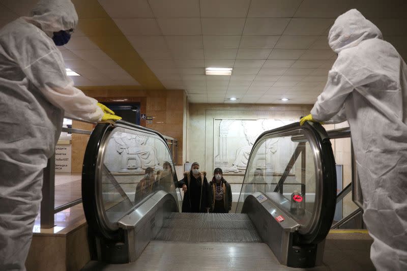 FILE PHOTO: Workers disinfect an escalator in Serdika metro station in Sofia