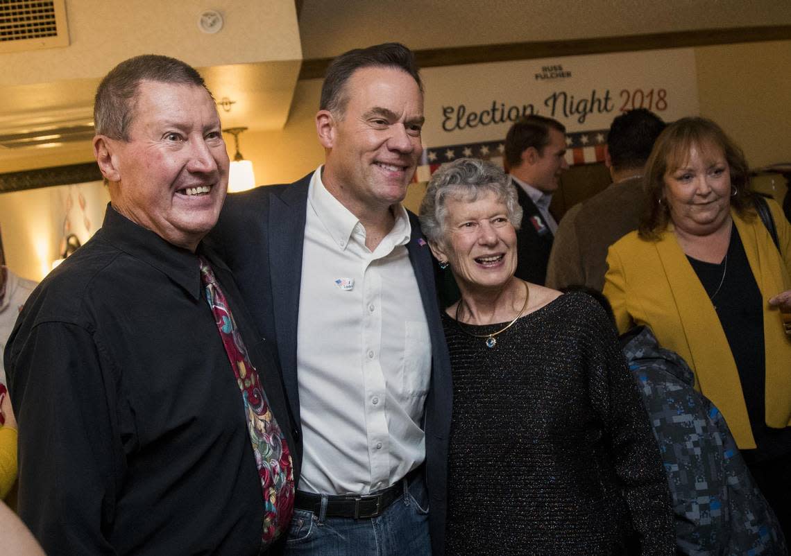 Russ Fulcher poses for a photo with friends Dieter and Regina Bayer, of Meridian, at the Republican election night party at the Riverside Hotel.