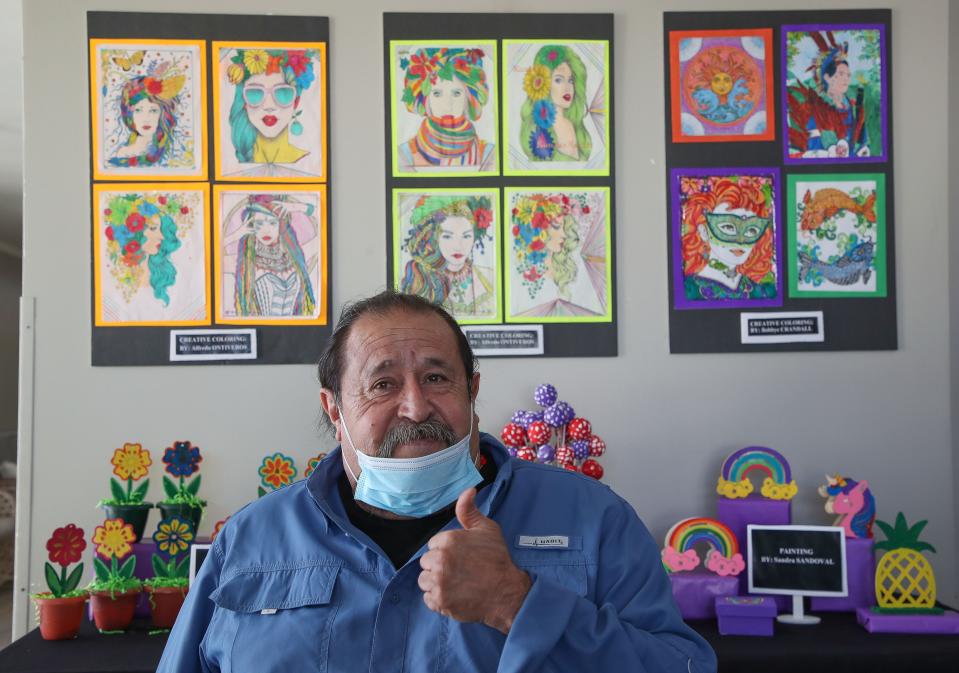 Alfredo Ontiveros shows some of his artwork which is on display at the California Nursing and Rehabilitation Center's art showcase in Palm Springs, Calif., Feb. 22, 2023.