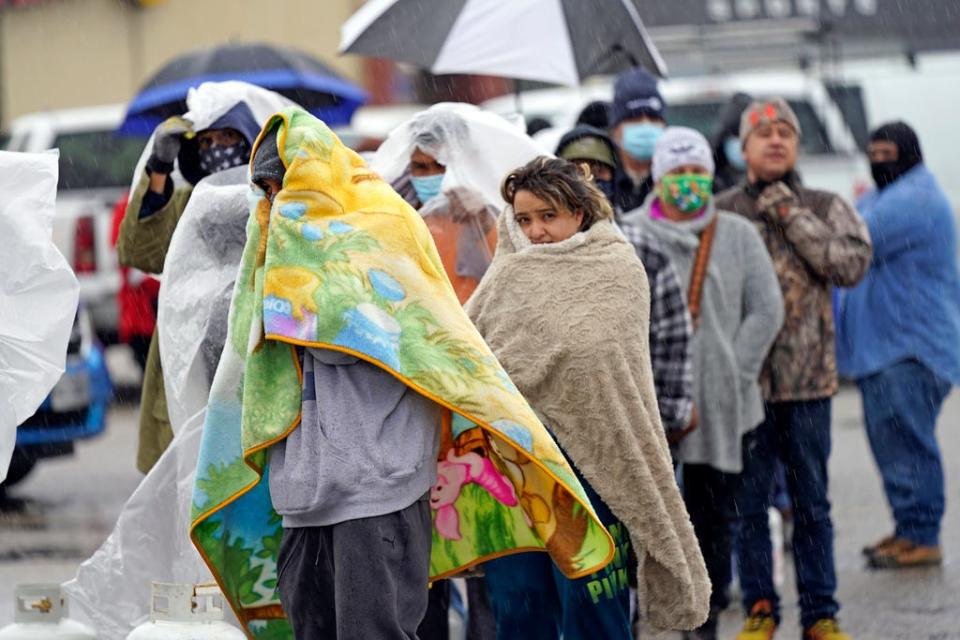 People waited in line for more than an hour in freezing rain to fill propane tanks on Feb. 17, 2021,  in Houston.