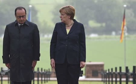 French President Francois Hollande and German Chancellor Angela Merkel attend a remembrance ceremony at a German cemetery in Consenvoye near Verdun, France, May 29, 2016, marking the 100th anniversary of the battle of Verdun, one of the largest battles of the First World War (WWI) on the Western Front. REUTERS/Jean-Christophe Verhaegen/Pool