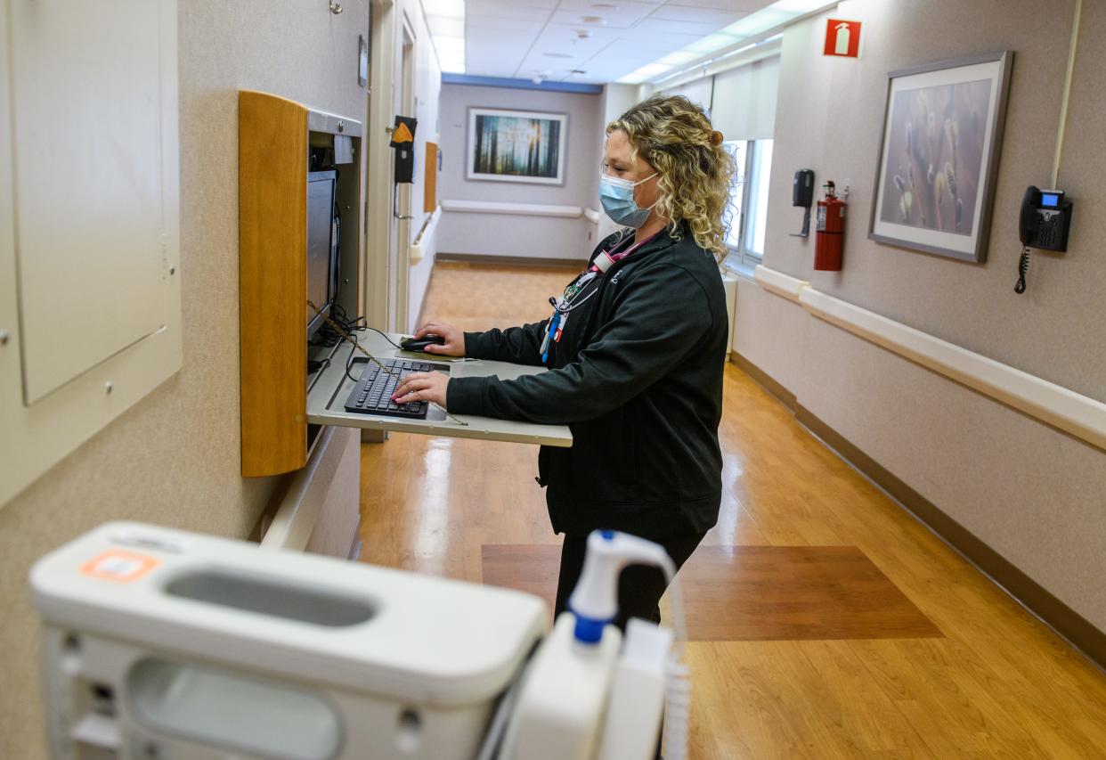 OSF St. Francis Medical Center registered nurse Erika Hulvey works at the charting station on the fourth floor of the hospital in downtown Peoria.