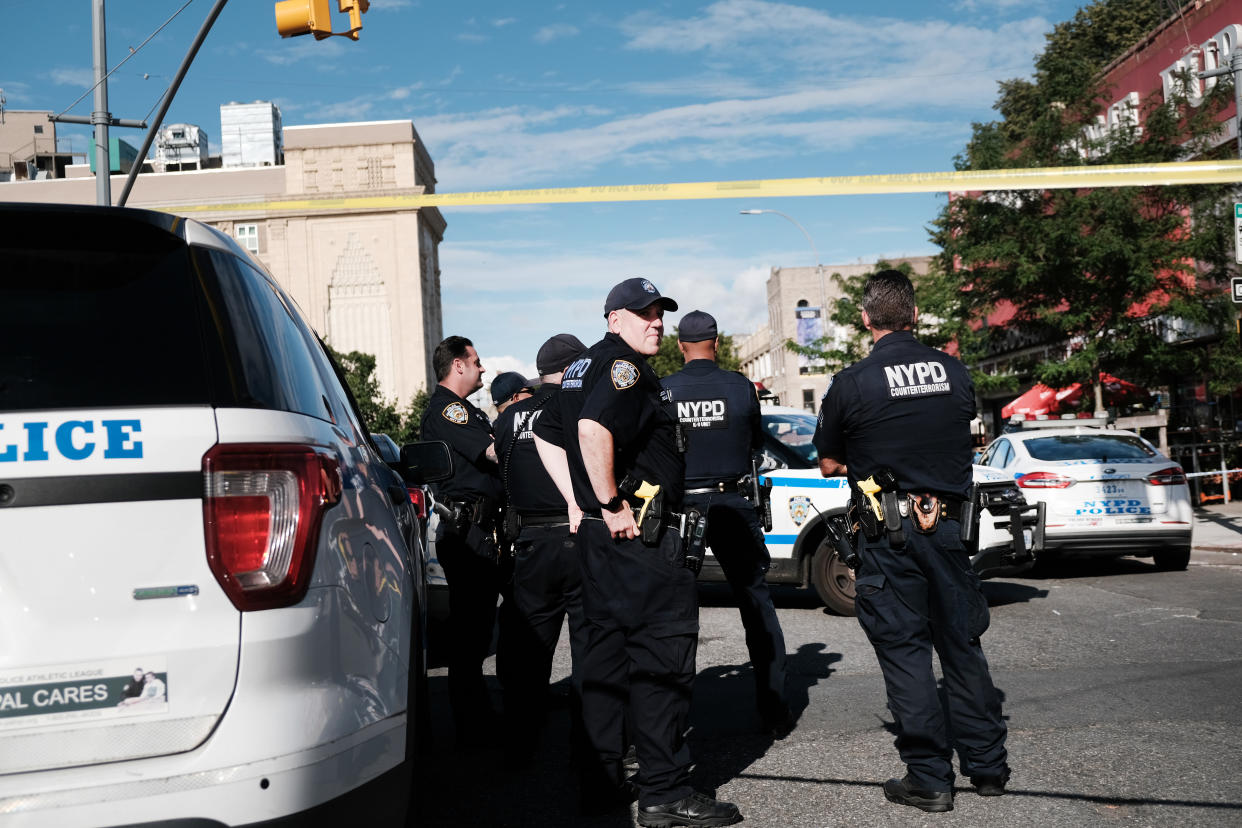 Police gather at the scene of a shooting 