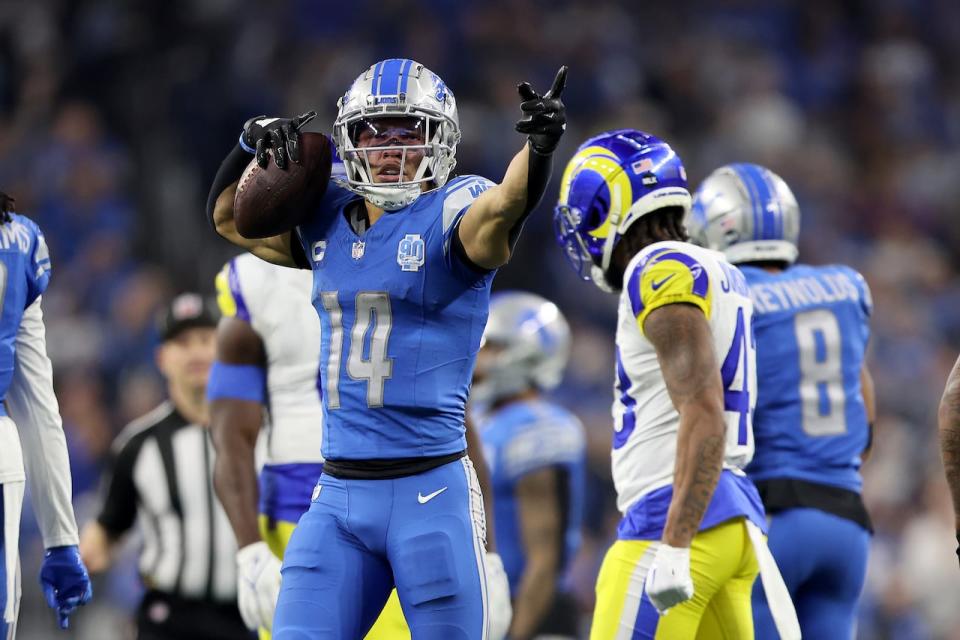 DETROIT, MICHIGAN - JANUARY 14: Amon-Ra St. Brown #14 of the Detroit Lions reacts after making a first down during the third quarter against the Los Angeles Rams in the NFC Wild Card Playoffs at Ford Field on January 14, 2024 in Detroit, Michigan. (Photo by Rey Del Rio/Getty Images)