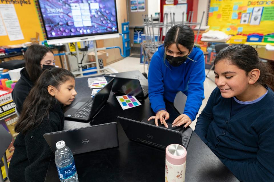 The poster and graphics design arm of the southwest Detroit's Clippert Multicultural Magnet Honors Academy robotics team Emily Carrillo-Chavez, 11, left, Aixa Lozano, 11, Danna Hurtado-Ramirez, 11, and Valentina Fuentes, 11, prepare for an upcoming competition Tuesday, Nov. 22, 2022.