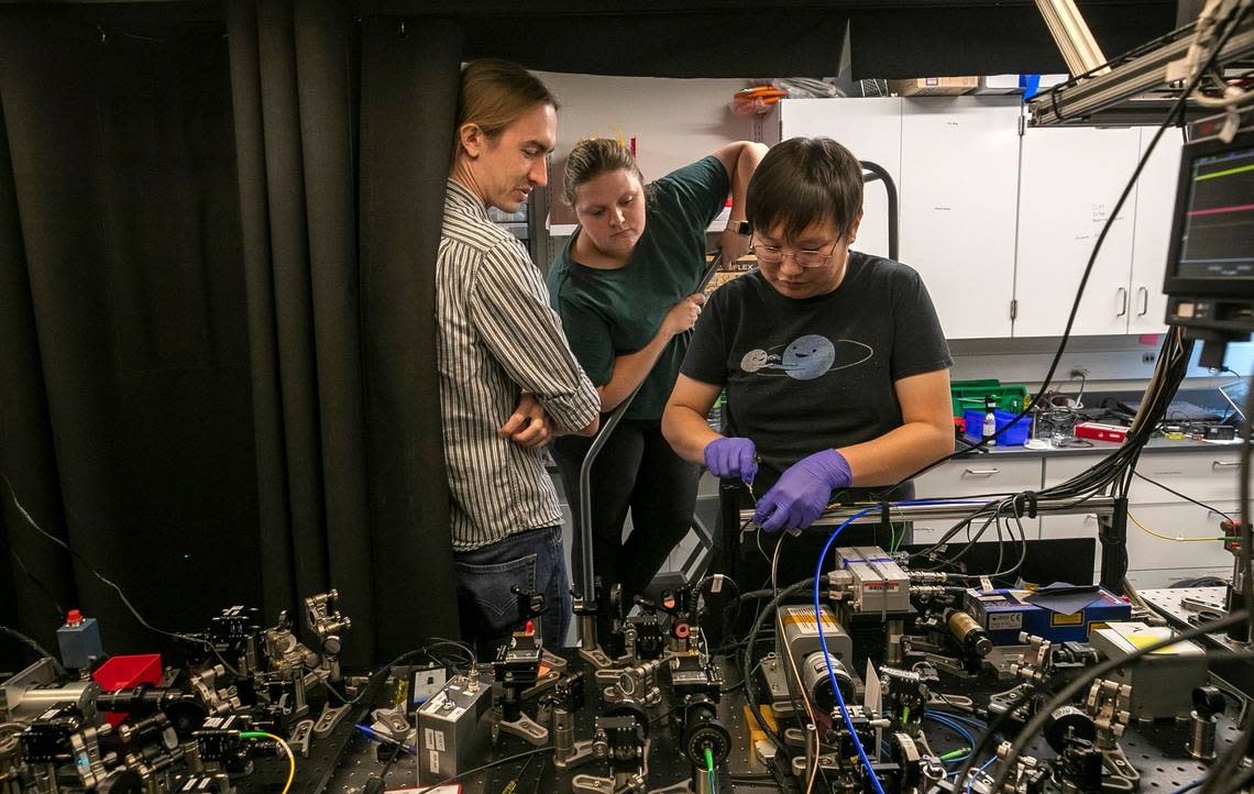 Duke Phd students Jameson O’Reilly and Isabella Goetting watch George Toh, a Duke postdoctoral student, as he works connecting multiple quantum computers at the Duke Quantum Center on Thursday, August 30, 2022 in Durham, N.C.