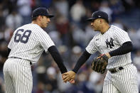 New York Yankees pitcher Jacob Barnes (68) and Gleyber Torres celebrate after a baseball game against the Baltimore Orioles on Saturday, Oct. 1, 2022, in New York. The Yankees won 8-0. (AP Photo/Adam Hunger)