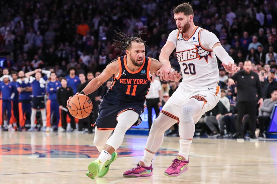 New York Knicks guard Jalen Brunson (11) drives past Phoenix Suns center Jusuf Nurkic (20) in the fourth quarter at Madison Square Garden on Nov. 26, 2023.