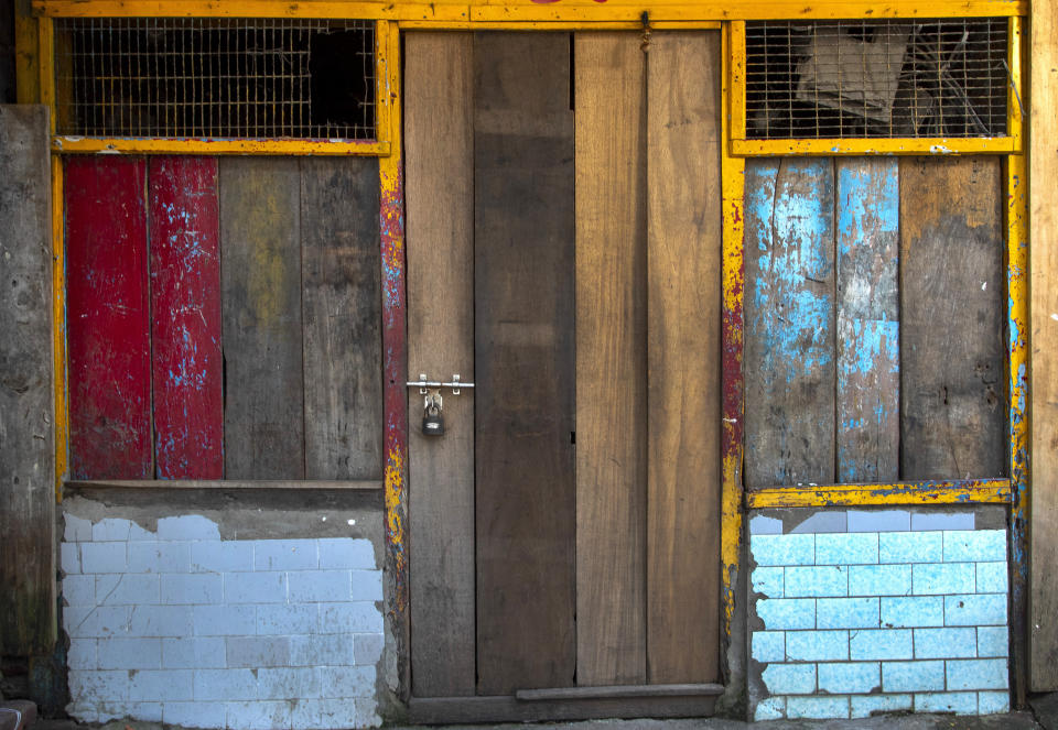 A shop is seen locked at a market area in Gauhati, India, on June 18, 2021. Rows of locked shops confront bargain-hunters for most of the day in Fancy Bazar, a nearly 200-year-old market that offered cheap prices until the COVID-19 pandemic hit Gauhati, the biggest city in India’s remote northeast. (AP Photo/Anupam Nath)