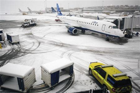 Airplanes wait at the gate at Logan Airport as weather causes flight cancellations and delays during a winter storm in Boston, Massachusetts, February 5, 2014. REUTERS/Dominick Reuter