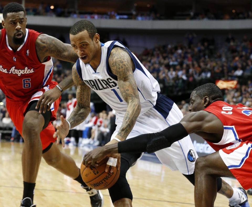 Los Angeles Clippers guard Darren Collison, right, strips the ball from Dallas Mavericks guard Monta Ellis (11) during the second half of an NBA basketball game Friday, Jan. 3, 2014, in Dallas. At left is Clippers' DeAndre Jordan. The Clippers won 119-112. (AP Photo/Sharon Ellman)