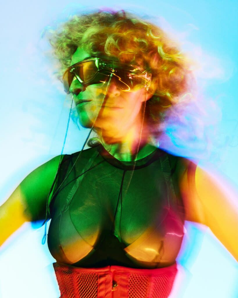 Stylised image of a drag artist against a gradient backdrop