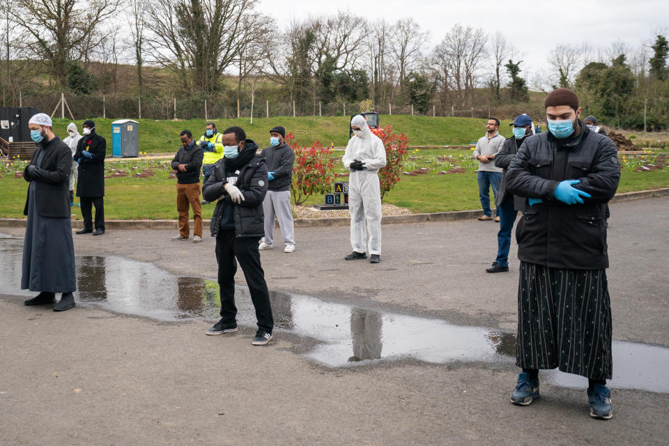 Mourners in face masks and gloves at the 13-year-old boy's funeral at Chislehurst. They practised social distancing during the funeral.