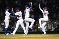 Chicago Cubs' P.J. Higgins, Nelson Velazquez, Patrick Wisdom and Christopher Morel, from left, celebrate the team's 15-7 win over the Cincinnati Reds in baseball game Thursday, June 30, 2022, in Chicago. (AP Photo/Charles Rex Arbogast)