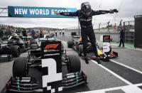 Mercedes driver Lewis Hamilton of Britain jumps out of his car after his record breaking 92nd win at the Formula One Portuguese Grand Prix at the Algarve International Circuit in Portimao, Portugal, Sunday, Oct. 25, 2020. (Jorge Guerrero, Pool via AP)