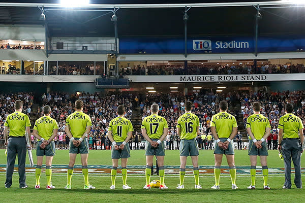 The umpires take a moment before the West Coast v Melbourne match.