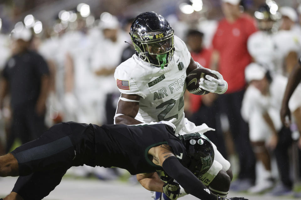 Hawaii defensive back Meki Pei (7) hits Air Force running back John Lee Eldridge III (24) during the first half of an NCAA college football game Saturday, Nov. 11, 2023, in Honolulu. (AP Photo/Marco Garcia)