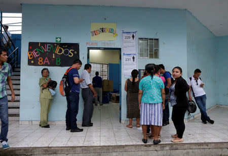 People stand outside a classroom in a school used as a polling station during the presidential election, in Guayaquil, Ecuador April 2, 2017. REUTERS/Henry Romero