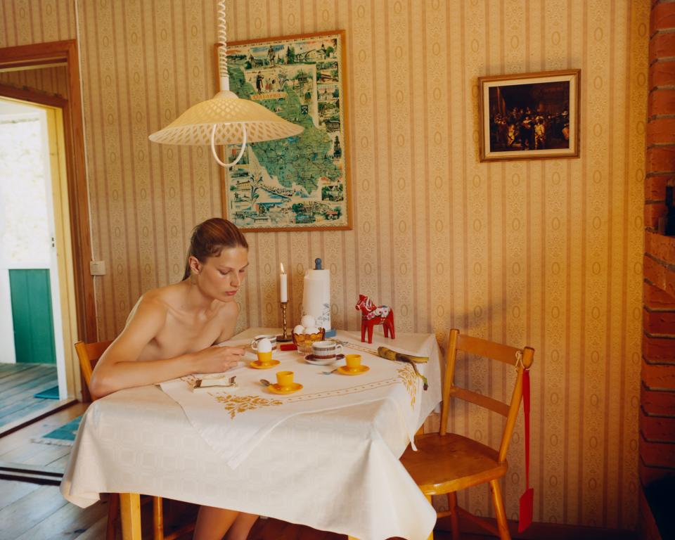 Adela eating an egg in the cabin. Notice the regional map of Dalarna hanging on the wall. Also the little wooden toy horse on the table, a typical Dalecarlian artifact.