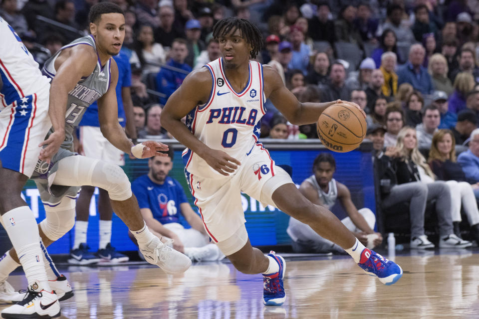 Philadelphia 76ers guard Tyrese Maxey (0) drives past Sacramento Kings forward Keegan Murray during the first quarter of an NBA basketball game in Sacramento, Calif., Saturday, Jan. 21, 2023. (AP Photo/Randall Benton)