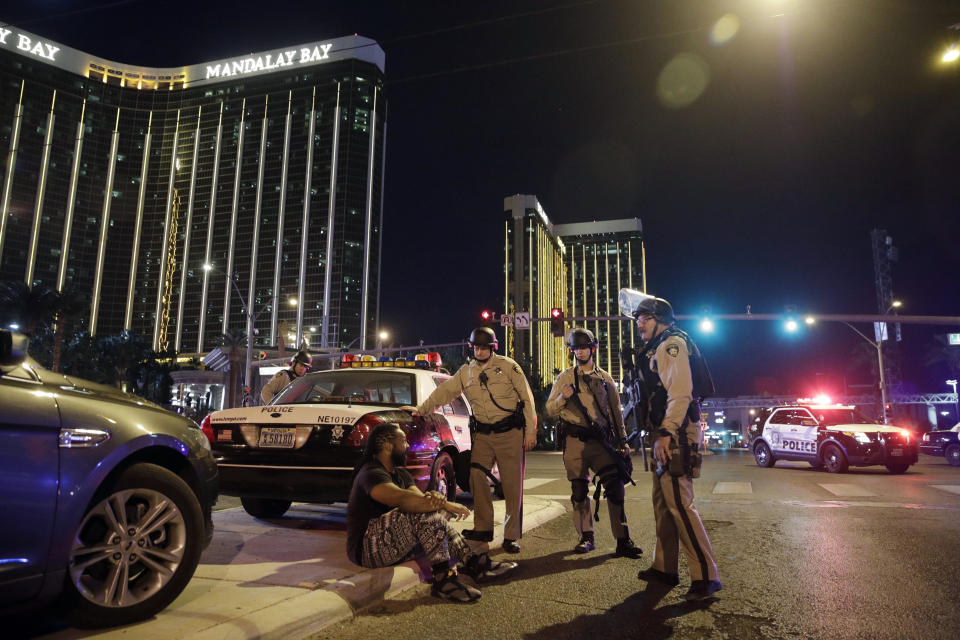 FILE - In this Oct. 1, 2017 file photo, police officers stand at the scene of a shooting near the Mandalay Bay resort and casino on the Las Vegas Strip in Las Vegas. In a report released Tuesday, Jan. 29, 2019, the FBI concluded its investigation into the deadliest mass shooting in modern U.S. history without determining a motive. After nearly 16 months, the agency says it can't determine why gunman Stephen Paddock killed 58 people and injured nearly 900 others in October 2017. (AP Photo/John Locher, File)