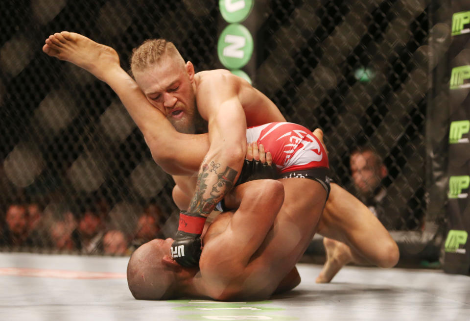 <p>While Rousey’s star rose, so too did that of brash Irishman Conor McGregor. “The Notorious” had his first UFC main event on a memorable July night in Dublin. Irish fighters went 5-0 on the evening, culminating in McGregor bringing the roof down at sold-out O2 Arena with his first-round win over Diego Brandao. (PA Images) </p>