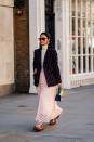 <p>A guest photographed at London Fashion Week in a chic turtleneck, sheer skirt and chunky dad trainers. <em>[Photo: Getty]</em> </p>