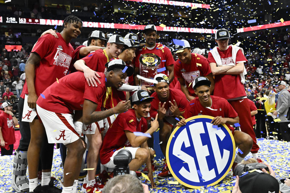 Alabama players pose after an NCAA college basketball game against Texas A&M in the finals of the Southeastern Conference Tournament, Sunday, March 12, 2023, in Nashville, Tenn. Alabama won 82-63. (AP Photo/John Amis)