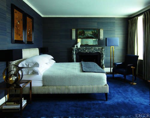 Grass cloth walls and a peacock blue carpet add textural intrigue to the bedroom inside this abode in London's Notting Hill neighborhood. Source: Elle Decor