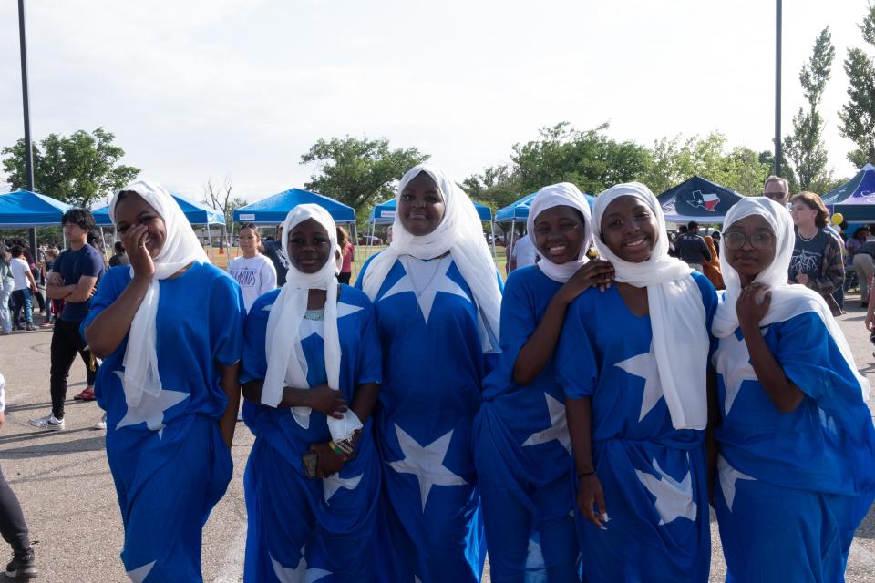 A group of Somali Americans wearing a dress featuring the national flag of Somalia waits their turn to entertain the audience Sunday at Trinity Fellowship in the Eastridge neighborhood of Amarillo.