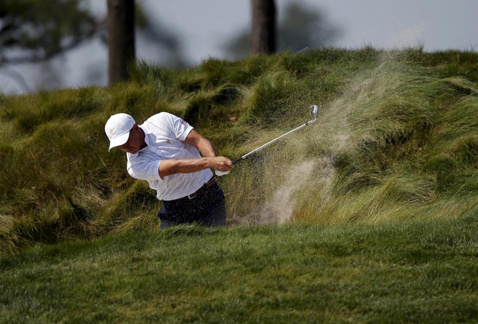 U.S. team member Rickie Fowler hits out of a bunker on the third hole during the opening foursome matches of the 2015 Presidents Cup golf tournament at the Jack Nicklaus Golf Club in Incheon