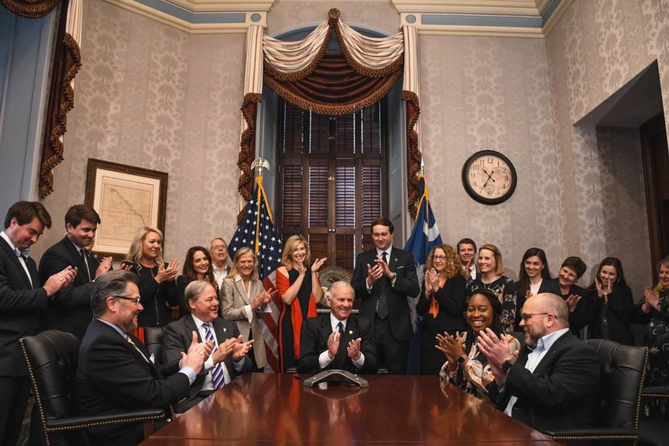 South Carolina Gov. Henry McMaster and members of his team applaud while receiving a call from Scout Motors CEO Scott Keogh announcing the company’s decision to launch an electric vehicle manufacturing plant in Richland County. South Carolina Officer of the Governor