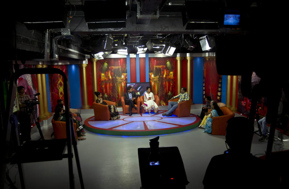 In this July 26, 2013 photo, Nidhi Gaur, left on stage, and her fiance Rahul Rai, right on stage, participate in "So It's Final," a talk show on Shagun TV that features engaged couples in Noida, India. Indians are obsessed with weddings and obsessed with reality television. Now Shagun TV, a new television channel headquartered in a sprawling suburb of India's capital, is hoping it has found a can't-miss idea — merging the two into a 24-hour matrimonial TV station.(AP Photo/Tsering Topgyal)