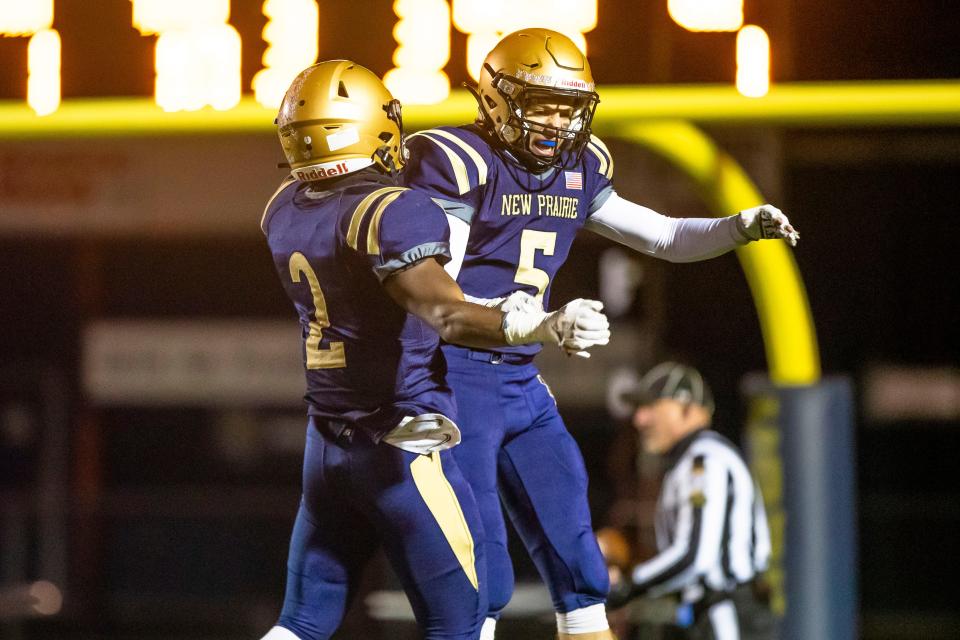 New Prairie's Noah Mungia (2) and Reece Lapczynski (5) celebrate during the New Prairie vs. Northridge regional championship football game Friday, Nov. 11, 2022 at New Prairie High School in New Carlisle.