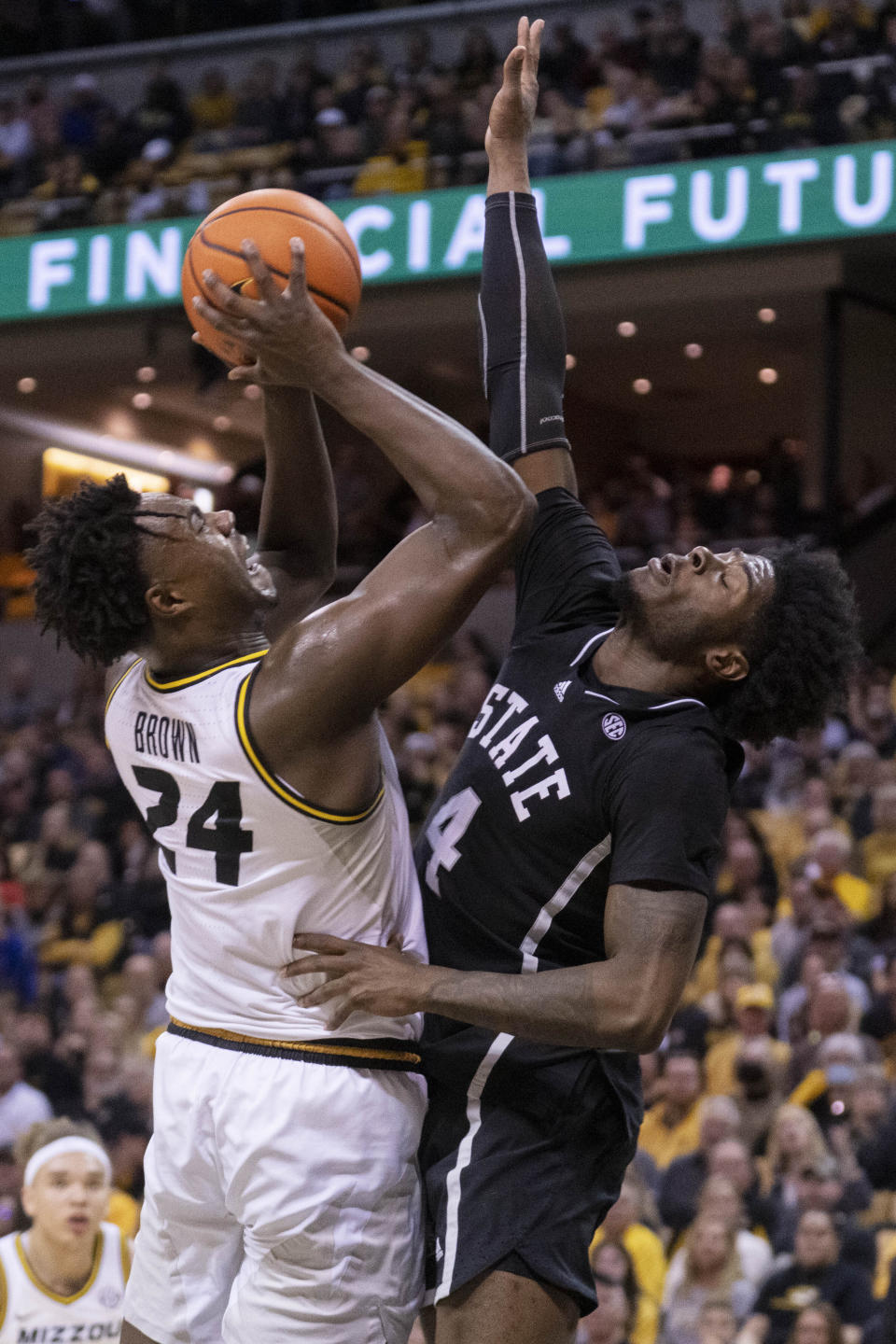 Missouri's Kobe Brown, left, shoots over Mississippi State's Cameron Matthews during the second half of an NCAA college basketball game Tuesday, Feb. 21, 2023, in Columbia, Mo. Missouri won 66-64 in overtime. (AP Photo/L.G. Patterson)