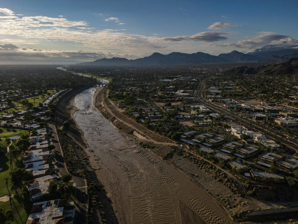 Floodwaters from Hilary flow east parallel to Highway 111 as the sun rises in Rancho Mirage on Monday, Aug. 21, 2023.