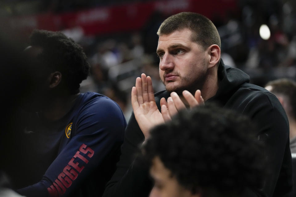 Denver Nuggets' Nikola Jokic applauds on the bench during the second half of a preseason NBA basketball game against the Los Angeles Clippers in Los Angeles, Tuesday, Oct. 17, 2023. (AP Photo/Ashley Landis)