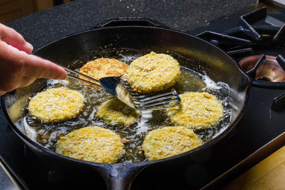 <p>Pan-frying is done by adding enough fat to a hot pan so that the pan is coated. This method tends to be at a lower heat than sauteing or searing. Pan-fried foods tend to be larger than those you sauté. Examples include <a href="https://www.thedailymeal.com/best-recipes/crab-cakes?referrer=yahoo&category=beauty_food&include_utm=1&utm_medium=referral&utm_source=yahoo&utm_campaign=feed" rel="nofollow noopener" target="_blank" data-ylk="slk:crab cakes" class="link ">crab cakes</a> or <a href="https://www.thedailymeal.com/recipes/fried-green-tomatoes-recipe-24?referrer=yahoo&category=beauty_food&include_utm=1&utm_medium=referral&utm_source=yahoo&utm_campaign=feed" rel="nofollow noopener" target="_blank" data-ylk="slk:fried green tomatoes" class="link ">fried green tomatoes</a>, which are cooked until golden brown on one side and then turned over so the other side can brown. </p>