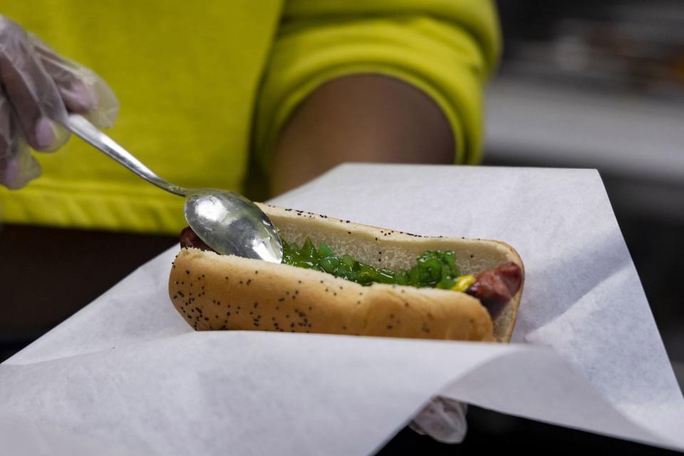 The Wiener's Circle char dog is prepared with green relish and other ingredients. (Brian Cassella/Chicago Tribune/Tribune News Service via Getty Images)