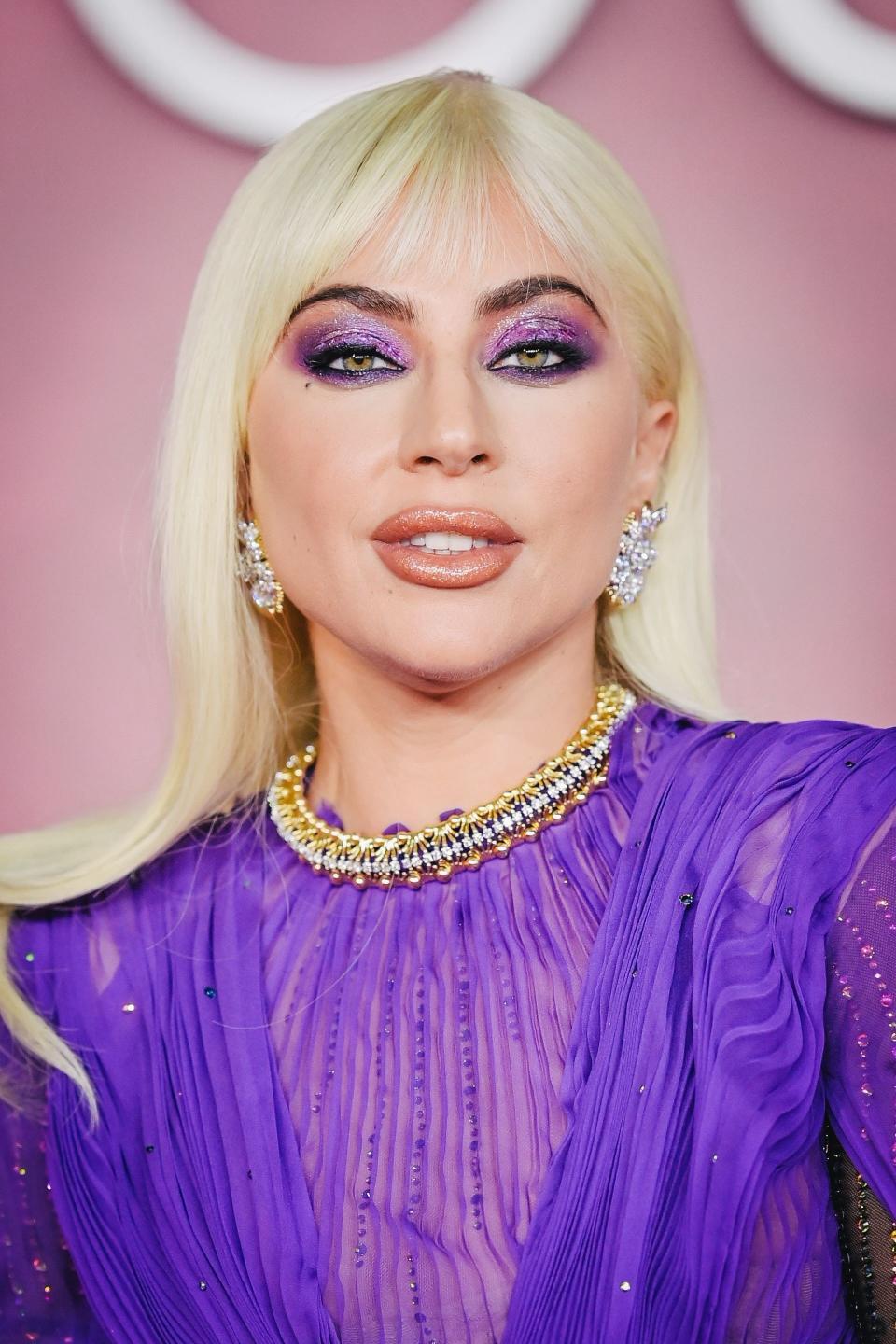 A close-up of Gaga's makeup, in which she has purple shimmer eyeshadow and a peach lip