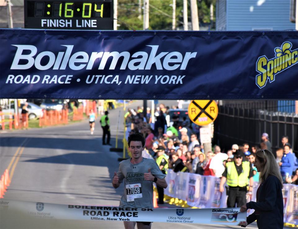 Michael Hennelly, a first-time Boilermaker participant from Suffern, reaches the finish line as the first 5K finisher Sunday.