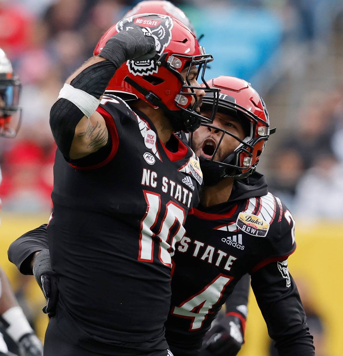 N.C. State’s Derrek Pitts Jr. (24) celebrates with Tanner Ingle (10) after Ingle tackled Maryland running back Roman Hemby (24) during the second half of Maryland’s 16-12 victory over N.C. State in the Duke’s Mayo Bowl at Bank of America Stadium in Charlotte, N.C., Friday, Dec. 30, 2022.