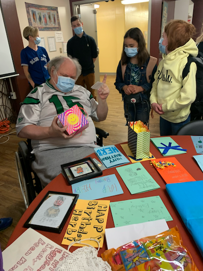 Herb receiving birthday cards from students in the iGen program. Author provided