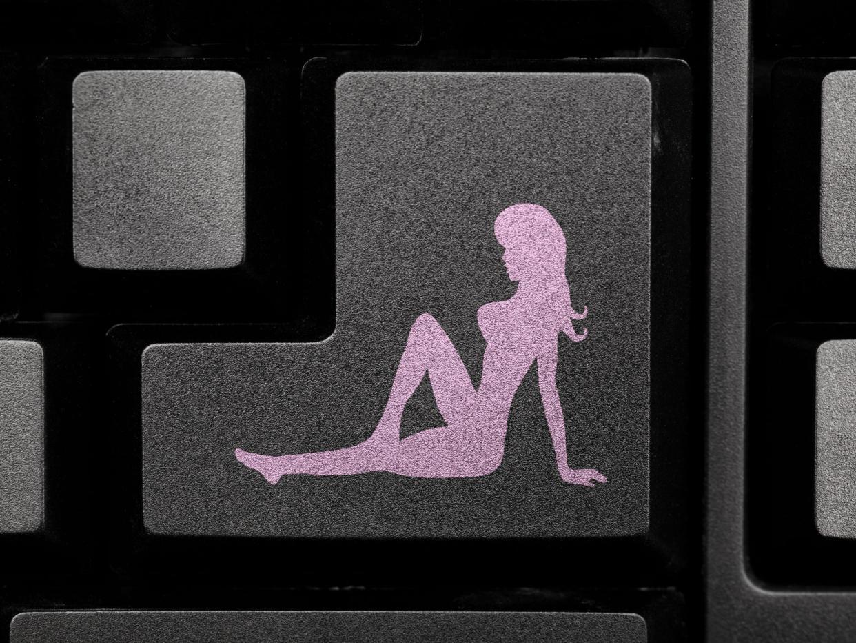 An icon of a woman on a keyboard.