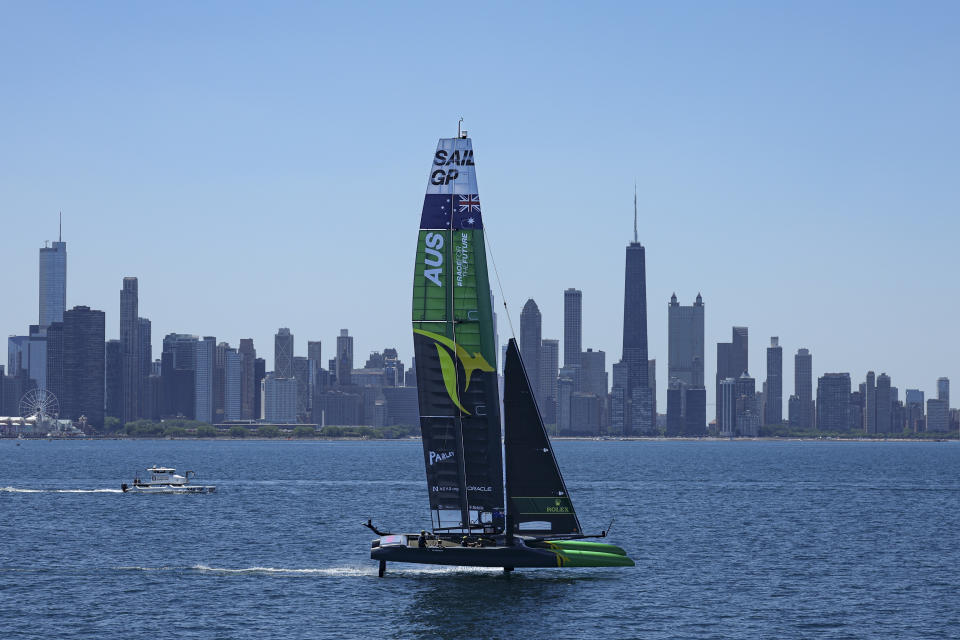 In this image provided by SailGP, Australia SailGP Team helmed by Tom Slingsby sail past the Chicago skyline ahead of United States Sail Grand Prix sailing race on Lake Michigan, Saturday, June 18, 2022, in Chicago. (Simon Bruty/SailGP via AP)