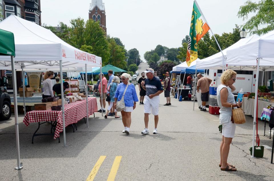 People browse through the Downtown Petoskey Farmers Market on Friday, July 23, 2021.