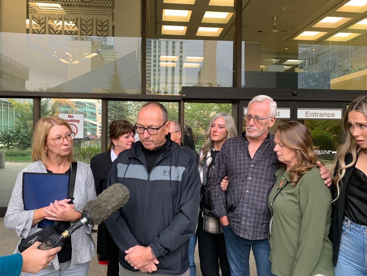 Bruce Coates, middle, speaks on behalf of the Coates family after the sentencing hearing on Thursday.  (Natasha Riebe/CBC - image credit)