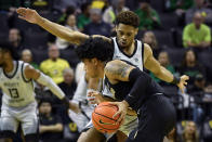 Oregon guard Keeshawn Barthelemy, top, applies pressure to Colorado guard Julian Hammond III, bottom, during the first half of an NCAA college basketball game Thursday, Jan. 26, 2023, in Eugene, Ore. (AP Photo/Andy Nelson)