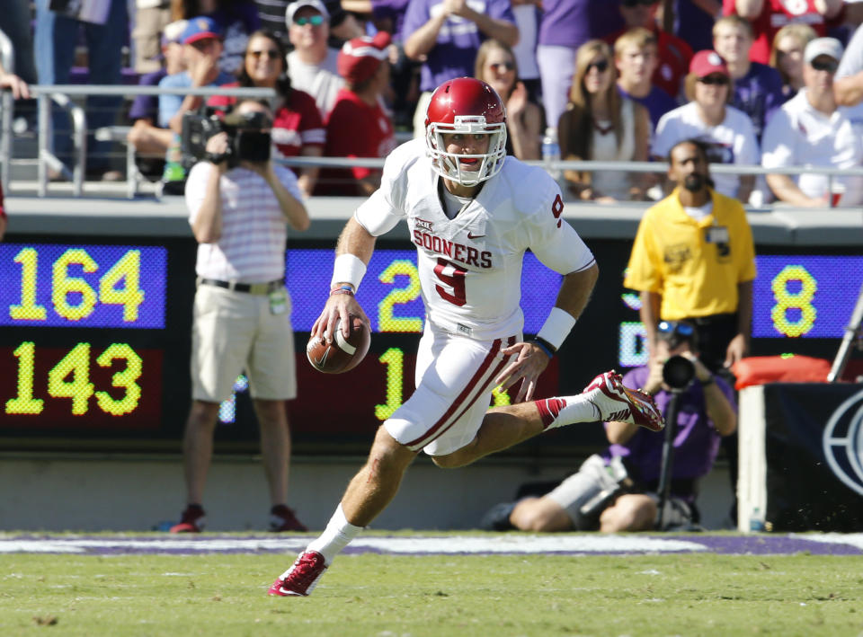 Oct. 4, 2014; Fort Worth, Texas; Oklahoma Sooners quarterback Trevor Knight (9) scrambles against the TCU Horned Frogs at Amon G. Carter Stadium. Matthew Emmons-USA TODAY Sports