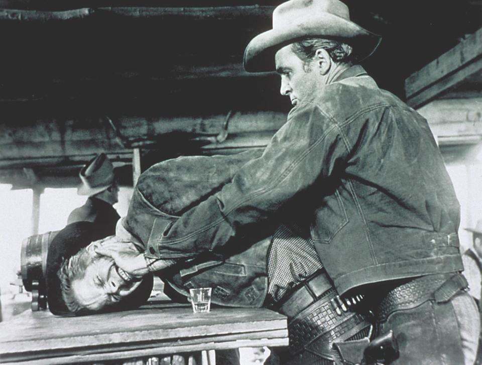 Stewart as Lin McAdam smashes Dan Duryea (Waco Johnnie Dean)’s face into a bar table in Anthony Mann’s Western ‘Winchester ’73’ (1950),  but even here, you give him the benefit of the doubt (Moviestore/Shutterstock)